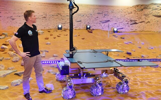 File: This photograph taken on February 07, 2019, shows British astronaut Tim Peake posing with a working prototype of the Rosalind Franklin ExoMars Rover following its naming ceremony at the Airbus Defence and Space facility in Stevenage, north of London. (Ben STANSALL / AFP)