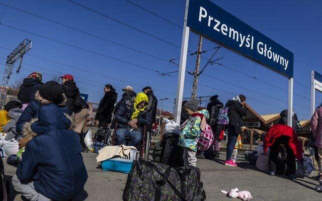 Refugees are seen as they wait for further transportation at the raiway station in Przemysl, Poland, on March 17, 2022. (Wojtek Radwanski/AFP)