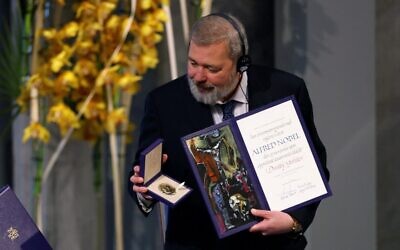 Nobel Peace Prize laureate Dmitry Muratov of Russia poses with the Nobel Peace Prize diploma and medal during the gala award ceremony for the Nobel Peace prize in Oslo on December 10, 2021. (Odd ANDERSEN / AFP)
