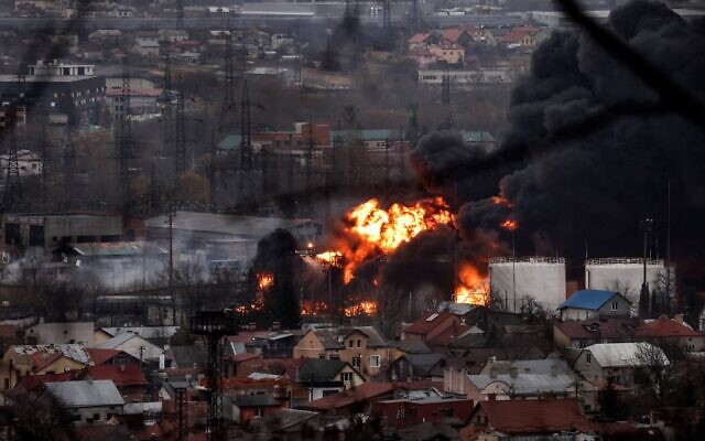Dark smoke and flames rise from a fire following an air strike in the western Ukrainian city of Lviv, on March 26, 2022. (Ronaldo Chemidt and Ronaldo Schemidt/AFP)