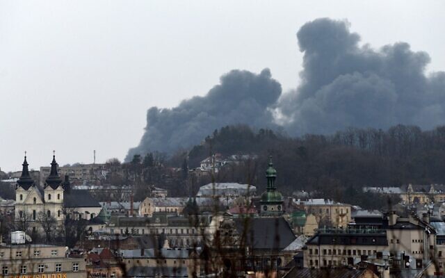 Dark smoke rises from a fire following an air strike in the western Ukrainian city of Lviv, on March 26, 2022. (Photo by Yuriy Dyachyshyn / AFP)