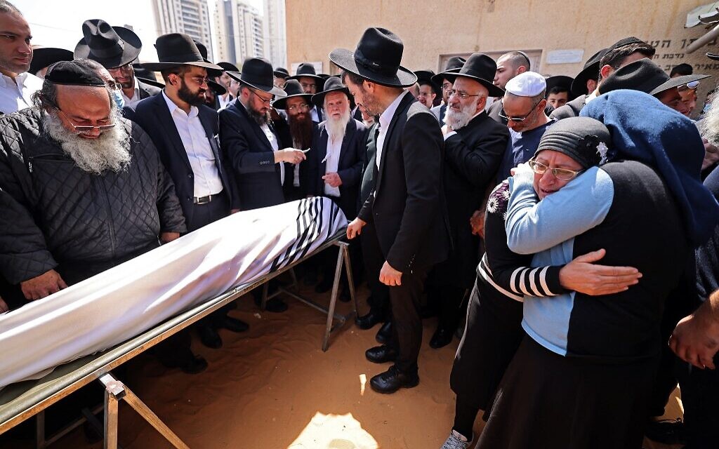Mourners attend the funeral of Avishai Yehezkel, one of the five people killed in a terror attack in Bnei Brak, on March 30, 2022 (Menahem KAHANA / AFP)