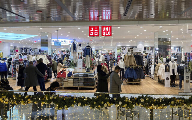 People shop at a Uniqlo retail clothing store in the Hudson Yards shopping mall in New York City on December 4, 2021. (AP Photo/Ted Shaffrey)