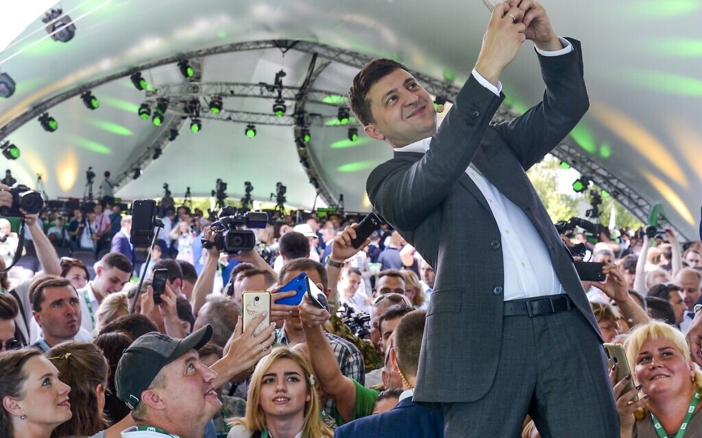 Illustrative: Ukrainian President Volodymyr Zelensky takes a selfie at the first congress of his party called Servant of the People in the city Botanical Garden, Kyiv, Ukraine, June 9, 2019. (AP Photo/Zoya Shu)