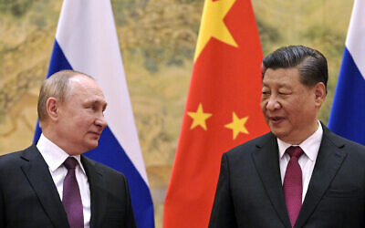 Chinese President Xi Jinping, right, and Russian President Vladimir Putin talk to each other during their meeting in Beijing, China on February 4, 2022. (Alexei Druzhinin, Sputnik, Kremlin Pool Photo via AP)