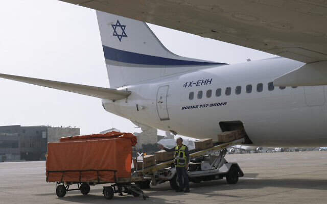 Workers load packages of Israeli humanitarian aid to assist people caught up in the fighting in Ukraine, in Ben Gurion airport, on March 1, 2022 (AP Photo/Tsafrir Abayov)