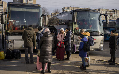 Ukrainians prepare to board a bus to Poland at Lviv bus main station, western Ukraine, March 1, 2022 (AP Photo/Bernat Armangue)