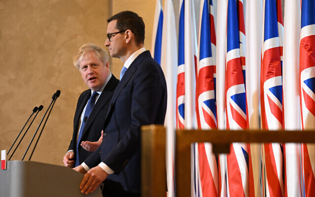 Britain's Prime Minister Boris Johnson, left, and Polish Prime Minister Mateusz Morawiecki take part in a press conference at the Chancellery, in Warsaw, Poland, March 1, 2022. (Leon Neal/Pool Photo via AP)