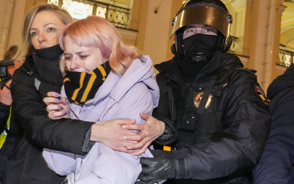 A Russian police officer, right, detains a demonstrator during an action against Russia's attack on Ukraine in St. Petersburg, Russia, Wednesday, March 2, 2022. (AP/Dmitri Lovetsky)