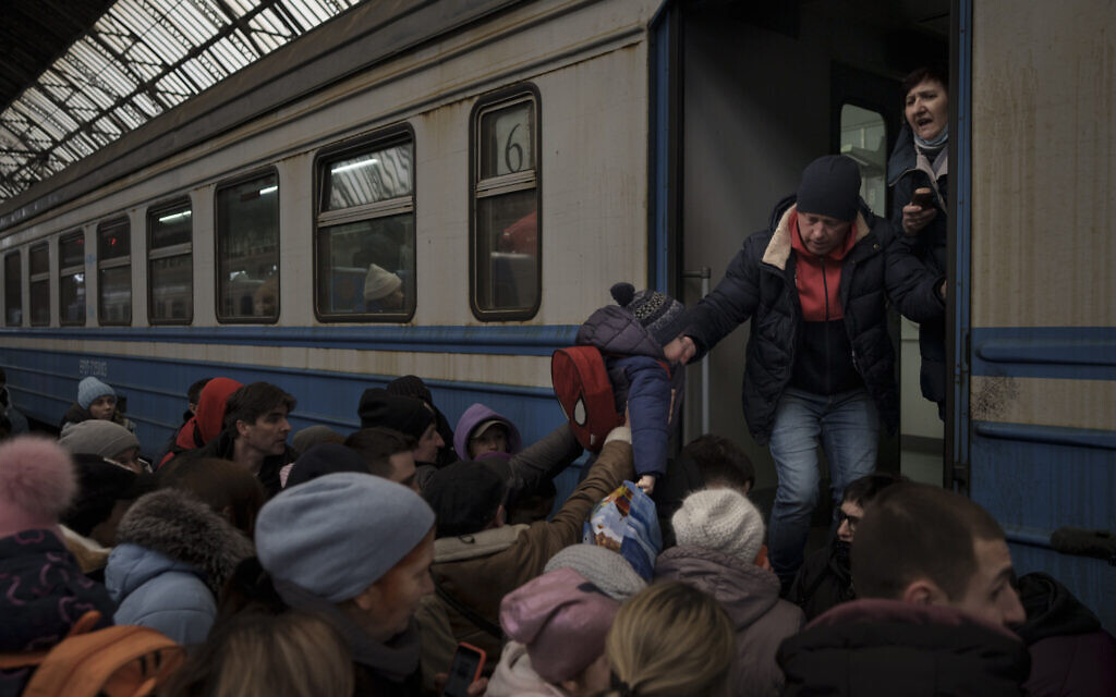 Passengers rush to board a train leaving to Slovakia from the Lviv railway station, in Lviv, west Ukraine, March 2, 2022. (AP/Felipe Dana)