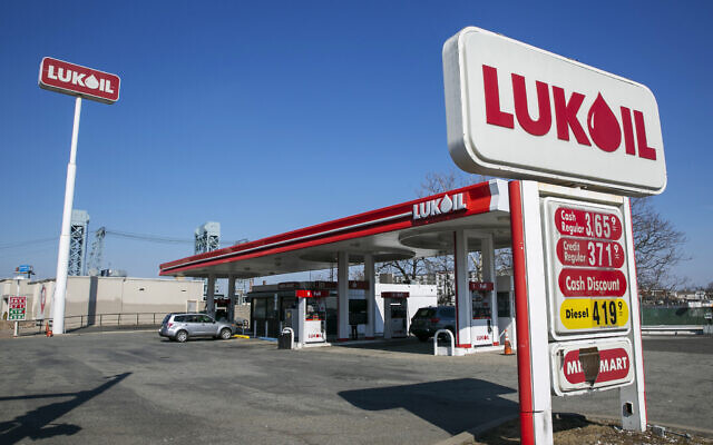 A worker pumps gas at a Lukoil station in Newark, New Jersey, on Wednesday, March 2, 2022.  (AP/Ted Shaffrey)