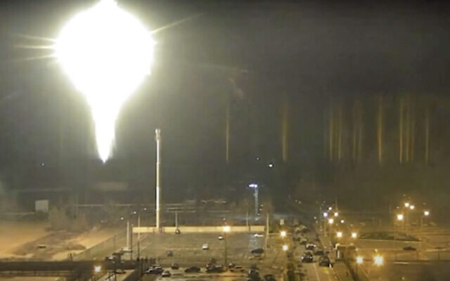 This image made from a video released by Zaporizhzhia nuclear power plant shows a bright flaring object landing in the grounds of the nuclear plant in Enerhodar, Ukraine, on March 4, 2022. (Zaporizhzhia nuclear power plant via AP)