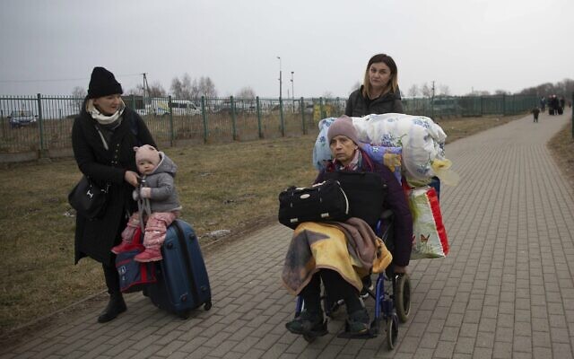 Refugees, mostly women with children, arrive at the border crossing in Medyka, Poland, March 5, 2022, after fleeing Russian invasion in Ukraine. (AP Photo/Visar Kryeziu)