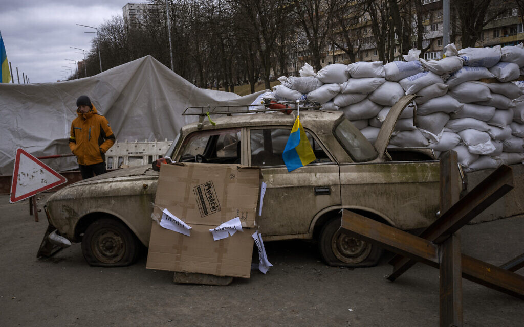 A militia man stands at a checkpoint set up on a road heading to the city of Kyiv, Ukraine, March 5, 2022. (AP Photo/Emilio Morenatti)