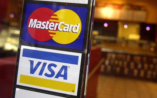 Illustrative: Logos for MasterCard and Visa credit cards at the entrance of a New York coffee shop (AP Photo/Mark Lennihan, File)