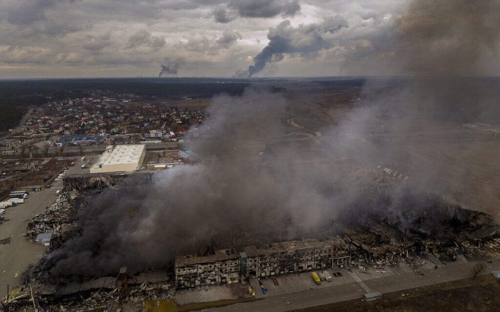 A factory and a store are burning after been bombarded in Irpin, in the outskirts of Kyiv, Ukraine, March 6, 2022. (AP Photo/Emilio Morenatti)