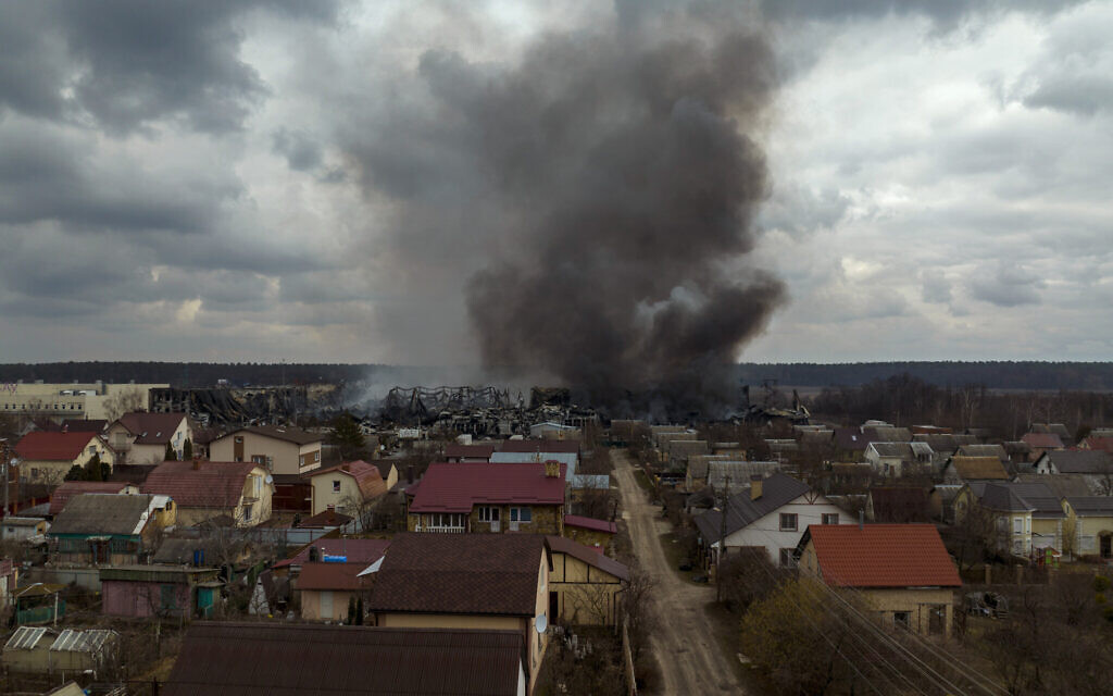 A factory and a store burn after being bombarded in Irpin, on the outskirts of Kyiv, Ukraine, March 6, 2022. (AP Photo/Emilio Morenatti)