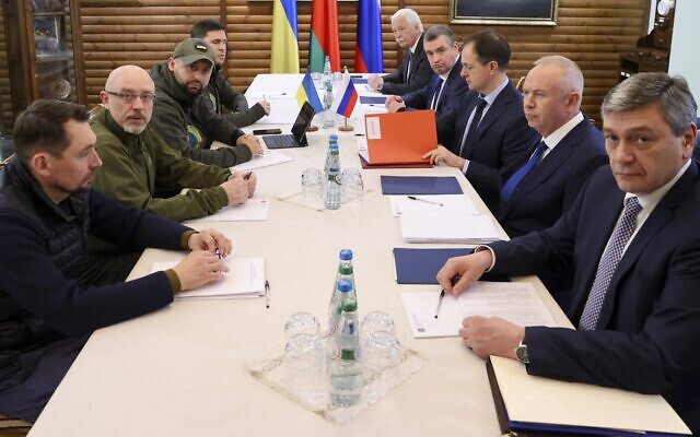 Ukraine's negotiation team (left) meets with the Russian delegation for talks in Belarus, close to the Polish-Belarusian border, March 7, 2022. (Maxim Guchek/BelTA Pool Photo via AP)