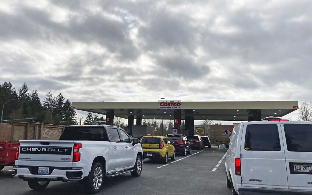 Cars line up for gas under a cloudy sky, Monday, March 7, 2022, at a Costco store in Lacey, Wash. (AP Photo/Ted S. Warren)