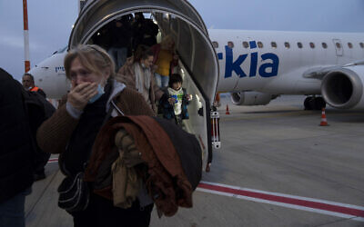 Ukrainians disembark from a special flight to Israel from Romania upon landing at Ben Gurion Airport, March 8, 2022  (AP Photo/Maya Alleruzzo)
