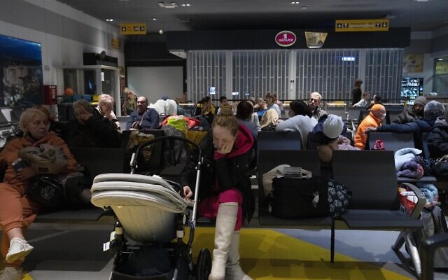 A Ukrainian woman waits with her baby at Iasi International Airport in Romania to board a flight to Israel, March 8, 2022. (AP Photo/Maya Alleruzzo)