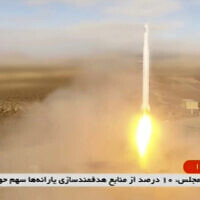 This image taken from video footage aired by Iranian state television on March 8, 2022, shows the launch of a rocket by Iran's Revolutionary Guard carrying a Noor-2 satellite in northeastern Shahroud Desert, Iran. (Iranian state television via AP)