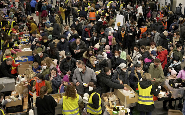 Ukrainian refugees queue for food in the welcome area after their arrival at the main train station in Berlin, Germany, March 8, 2022. (AP Photo/Michael Sohn)