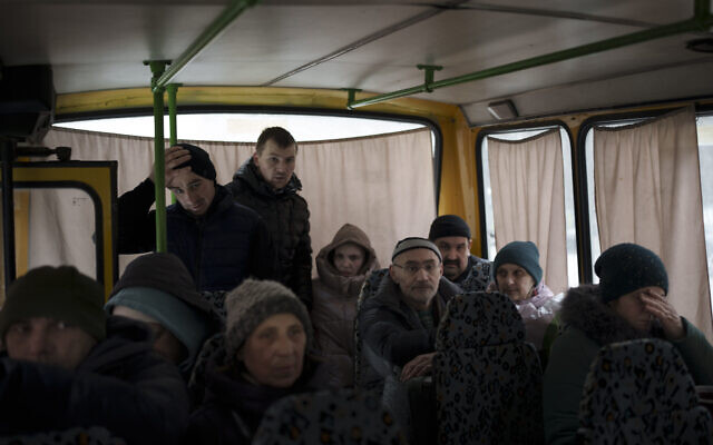 Ukrainians enter a bus as they are evacuated from Irpin, on the outskirts of Kyiv, Ukraine, Wednesday, March 9, 2022. (AP Photo/Felipe Dana)