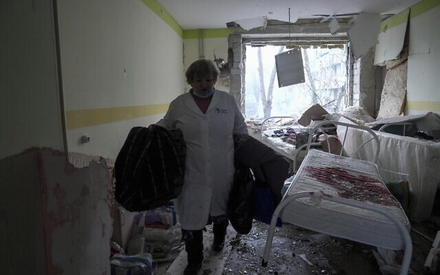 A medical worker walks inside a maternity hospital in Mariupol, Ukraine, Wednesday, March 9, 2022. A Russian attack severely damaged the hospital in the besieged port city, Ukrainian officials say. (AP Photo/Evgeniy Maloletka)