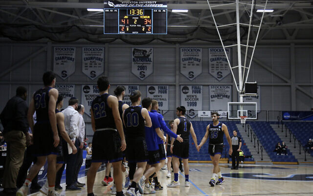 The Yeshiva Maccabees gather for a time out in the second half of a first round NCAA Division III basketball game against Johns Hopkins University, in Galloway Township, N.J., on Friday, March 4, 2022. (AP Photo/Jessie Wardarski)