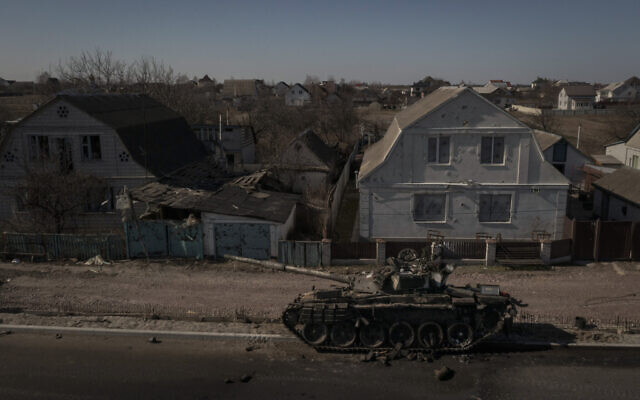 A destroyed tank is seen after battles between Ukrainian and Russian forces on a main road near Brovary, north of Kyiv, Ukraine, March 10, 2022. (AP Photo/Felipe Dana)