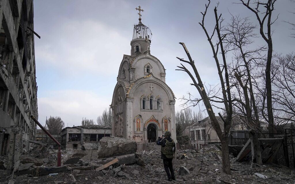 A Ukrainian serviceman takes a photograph of a damaged church after shelling in a residential district in Mariupol, Ukraine, March 10, 2022. (AP Photo/Evgeniy Maloletka)