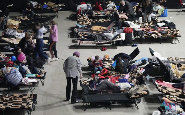 Refugees from the war in Ukraine seek shelter at a sports center in Warsaw, Poland, on March 11, 2022. (AP Photo/Czarek Sokolowski)