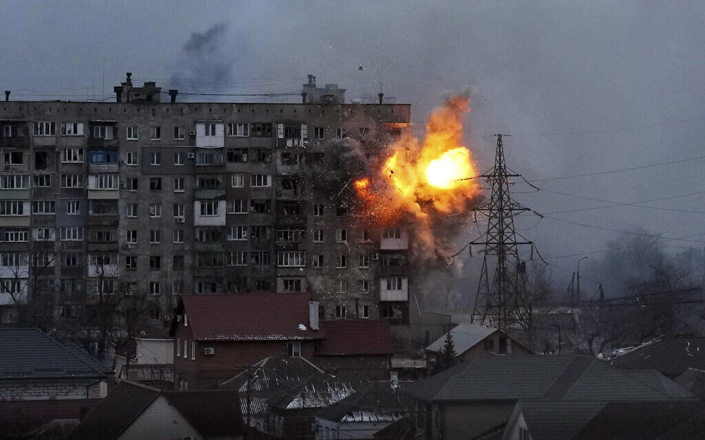 An explosion is seen in an apartment building after Russian's army tank fires in Mariupol, Ukraine, on March 11, 2022. (AP Photo/Evgeniy Maloletka)