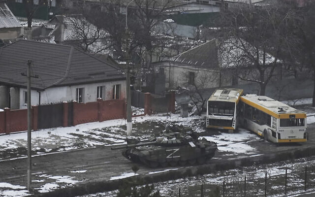 A Russian army tank moves through a street on the outskirts of Mariupol, Ukraine, March 11, 2022. (AP Photo/ Evgeniy Maloletka)