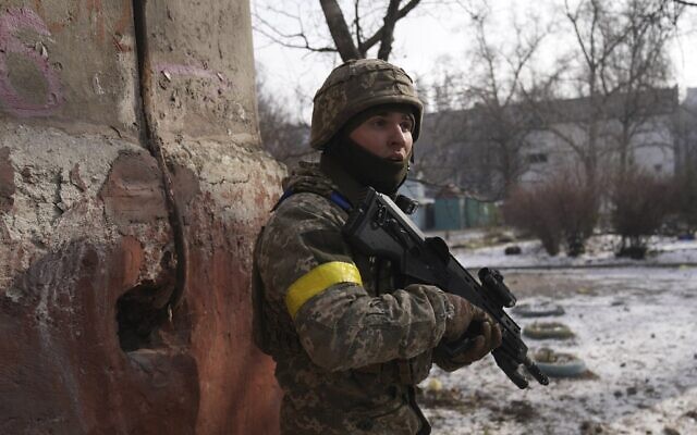A Ukrainian serviceman guards his position in Mariupol, Ukraine, March 12, 2022. (Evgeniy Maloletka/AP)