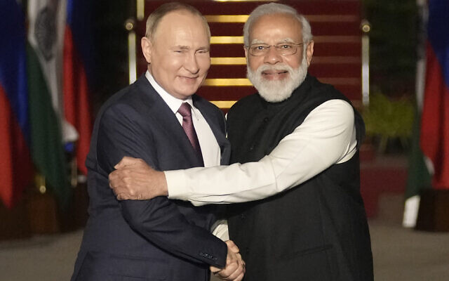 Russian President Vladimir Putin, left, and Indian Prime Minister Narendra Modi greet each other before their meeting in New Delhi, India on Dec. 6, 2021.  (AP Photo/Manish Swarup, File)