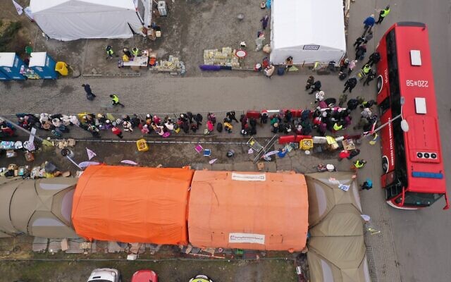 An aerial view of Ukrainian refugees waiting for transport at the border crossing at Medyka, Poland, March 13, 2022. (AP Photo)