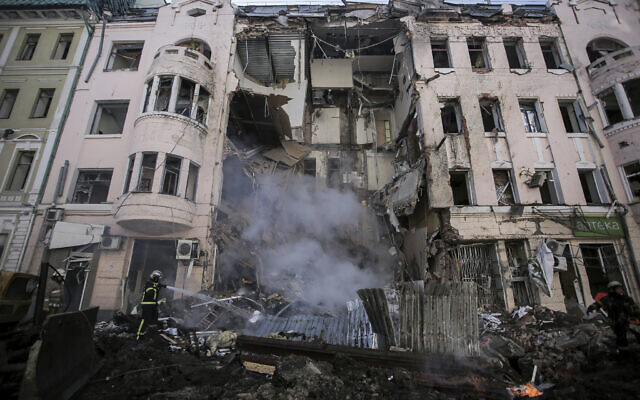 Firefighters extinguish an apartment house after a Russian rocket attack in Kharkiv, Ukraine's second-largest city, Ukraine, March 14, 2022. (AP Photo/Pavel Dorogoy)