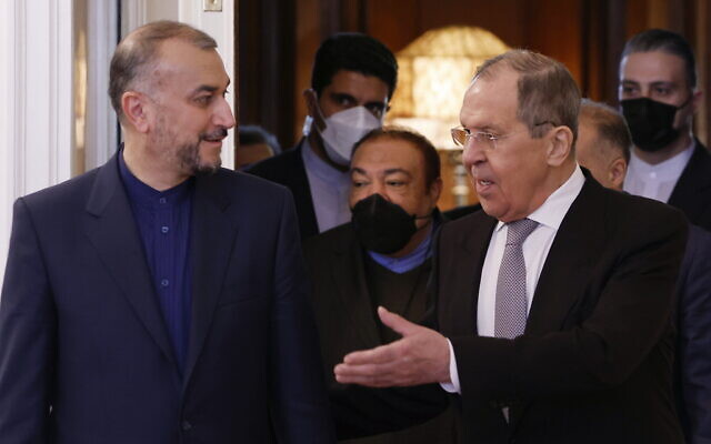 Russian Foreign Minister Sergey Lavrov, right, welcomes Iranian Foreign Minister Hossein Amir Abdollahian for the talks in Moscow, Russia, Tuesday, March 15, 2022. (Maxim Shemetov/Pool Photo via AP)