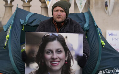 Richard Ratcliffe, the husband of detained charity worker Nazanin Zaghari-Ratcliffe, holds her photo outside the Foreign, Commonwealth and Development Office in London, on Nov. 9, 2021. (Frank Augstein/AP)
