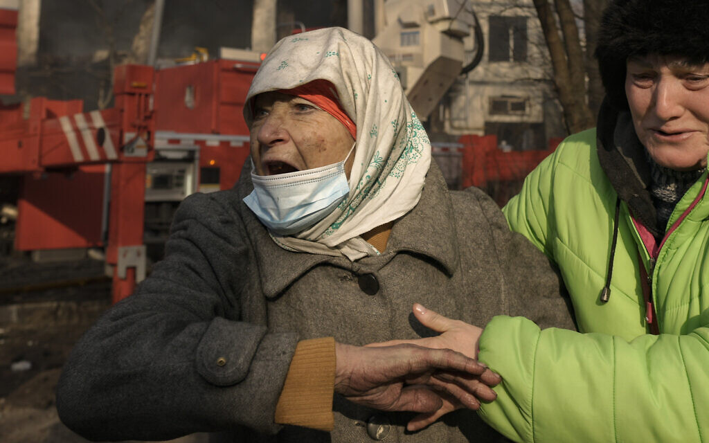 Women cry outside a destroyed apartment building after a bombing in a residential area in Kyiv, Ukraine, Tuesday, March 15, 2022.  (AP Photo/Vadim Ghirda)
