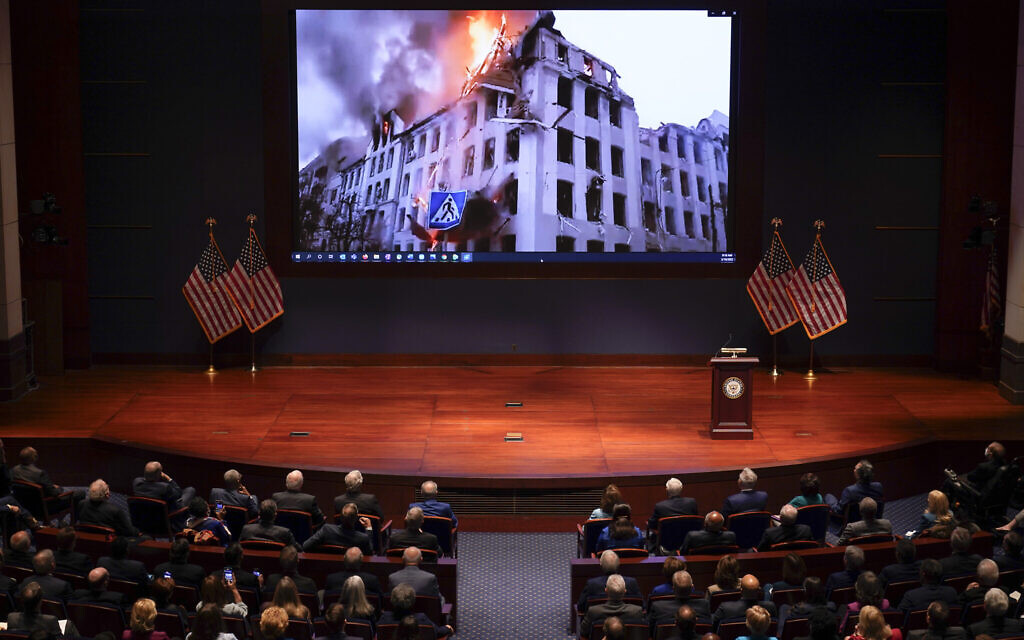 Footage of the war in Ukraine is displayed as Ukrainian President Volodymyr Zelensky speaks to the US Congress by video to plead for support as his country is besieged by Russian forces, at the Capitol in Washington, Wednesday, March 16, 2022. (AP/J. Scott Applewhite, Pool)