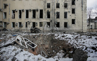 A view of a bomb crater after Russian shelling in the central of Kharkiv, Ukraine, on March 16, 2022. (Pavel Dorogoy/AP)