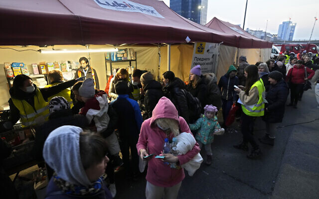 Ukrainian refugees pick up donated food and hygiene and bayby care products at the Warsaw Centralna train station, in Poland, March 16, 2022. (AP Photo/Czarek Sokolowski)