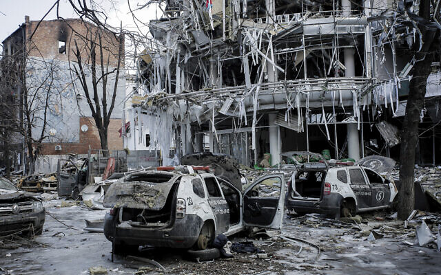 Damaged vehicles sit among debris and in Kharkiv city center in Ukraine, Wednesday, March 16, 2022. (AP Photo/Pavel Dorogoy)