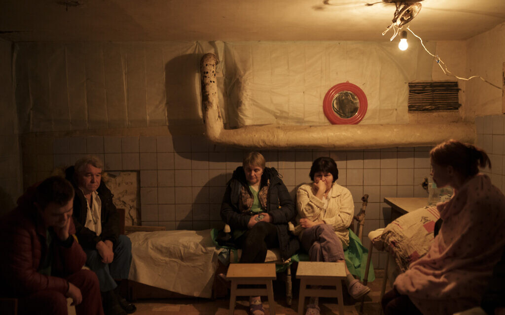 Hospital staff sit in a basement, used as a bomb shelter, during an air raid alarm in Brovary, north of Kyiv, Ukraine, March 17, 2022. (AP Photo/Felipe Dana)