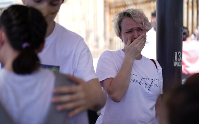 Irina Zolkina, who is seeking asylum in the United States, cries as she recalls her trip from Russia to the Mexican border, standing near the San Ysidro Port of Entry into the United States, in Tijuana, Mexico, Thursday, March 17, 2022. “It’s very hard to understand how they make decisions,” said Zolinka, a 40-year-old Russian woman who camped overnight with her family of seven after arriving in Tijuana on Thursday. (AP Photo/Gregory Bull)
