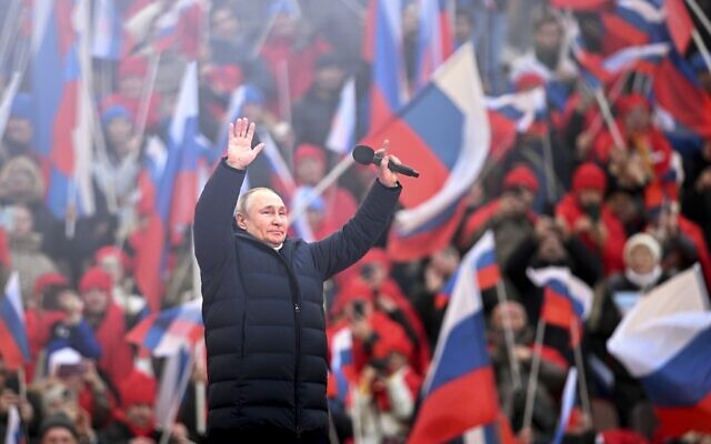 Russian President Vladimir Putin greets people after his speech at the concert marking the eighth anniversary of the referendum on the state status of Crimea and Sevastopol and its reunification with Russia, in Moscow, March 18, 2022. (Ramil Sitdikov/Sputnik Pool Photo via AP)