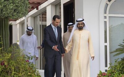 In this photo released by the official Facebook page of the Syrian Presidency, Syrian President Bashar Assad, left, walks next of Sheikh Mohammed bin Rashid Al Maktoum, vice president and prime minister of the UAE and the ruler of Dubai, in Dubai, United Arab Emirates, Friday, March 18, 2022 (Syrian Presidency Facebook page via AP)
